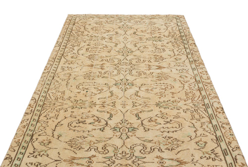 Load image 1 in gallery view. Beige and brown vintage-style rug with a distressed floral medallion pattern and a decorative border.