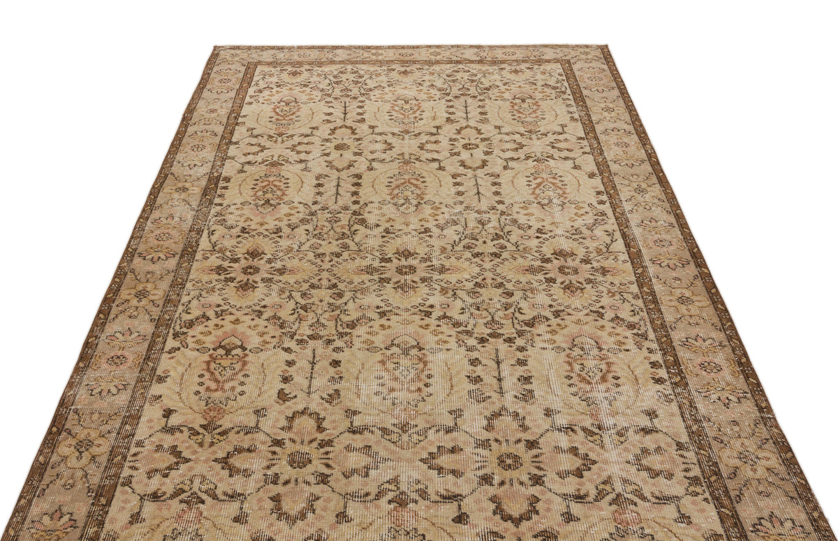 Beige and brown vintage-style rug with a distressed floral medallion pattern and a decorative border.
