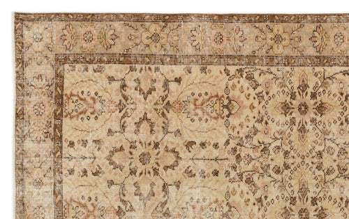 Load image 1 in gallery view. Distressed beige and brown rug with a traditional floral medallion pattern and a decorative border.