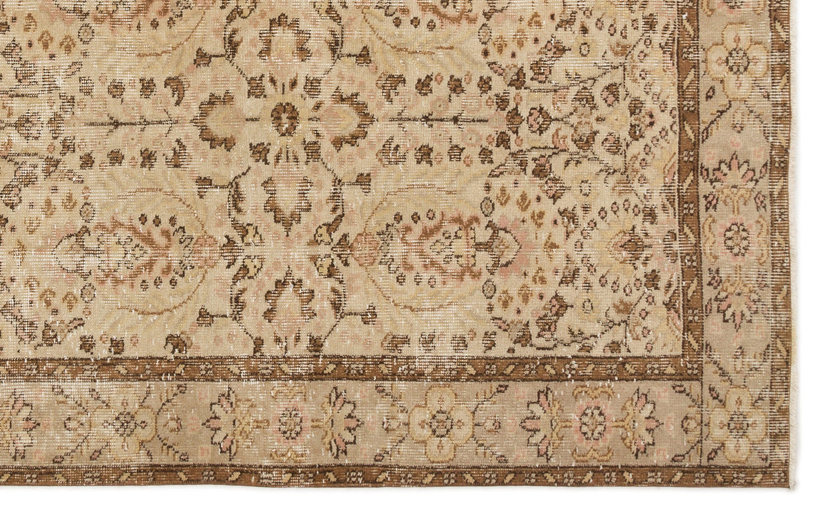 Beige and brown vintage-style rug with a distressed floral medallion pattern and a decorative border.