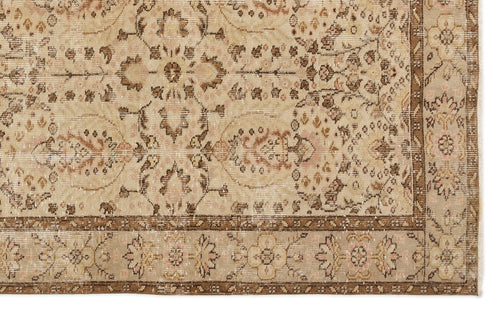 Load image 1 in gallery view. Beige and brown vintage-style rug with a distressed floral medallion pattern and a decorative border.
