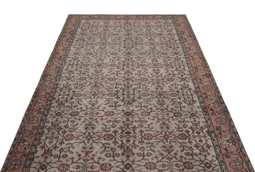 Load image 1 in gallery view. Beige and dusty rose vintage-style rug with an all-over floral vine pattern and a wide decorative border.