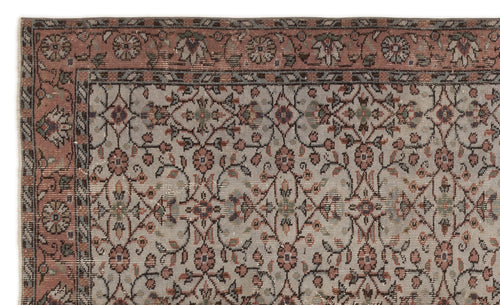Load image 1 in gallery view. Muted pink and grey traditional rug with a repeating floral medallion pattern and a decorative border.