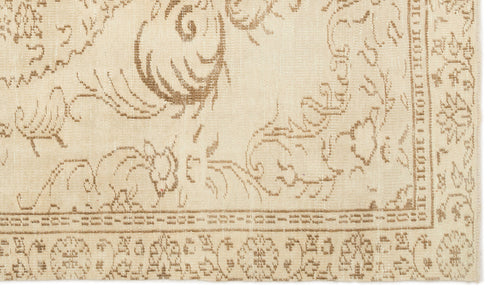Load image 1 in gallery view. Beige rug with a light brown traditional floral medallion pattern and a decorative geometric border.