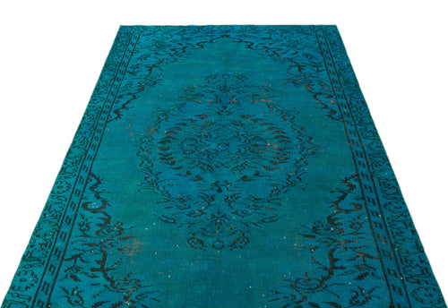 Load image 1 in gallery view. Teal and black distressed rug with a central floral medallion and ornate border pattern on a white background.