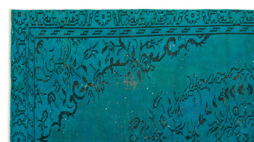 Load image 1 in gallery view. Teal rug with a distressed black floral medallion pattern and a geometric border.