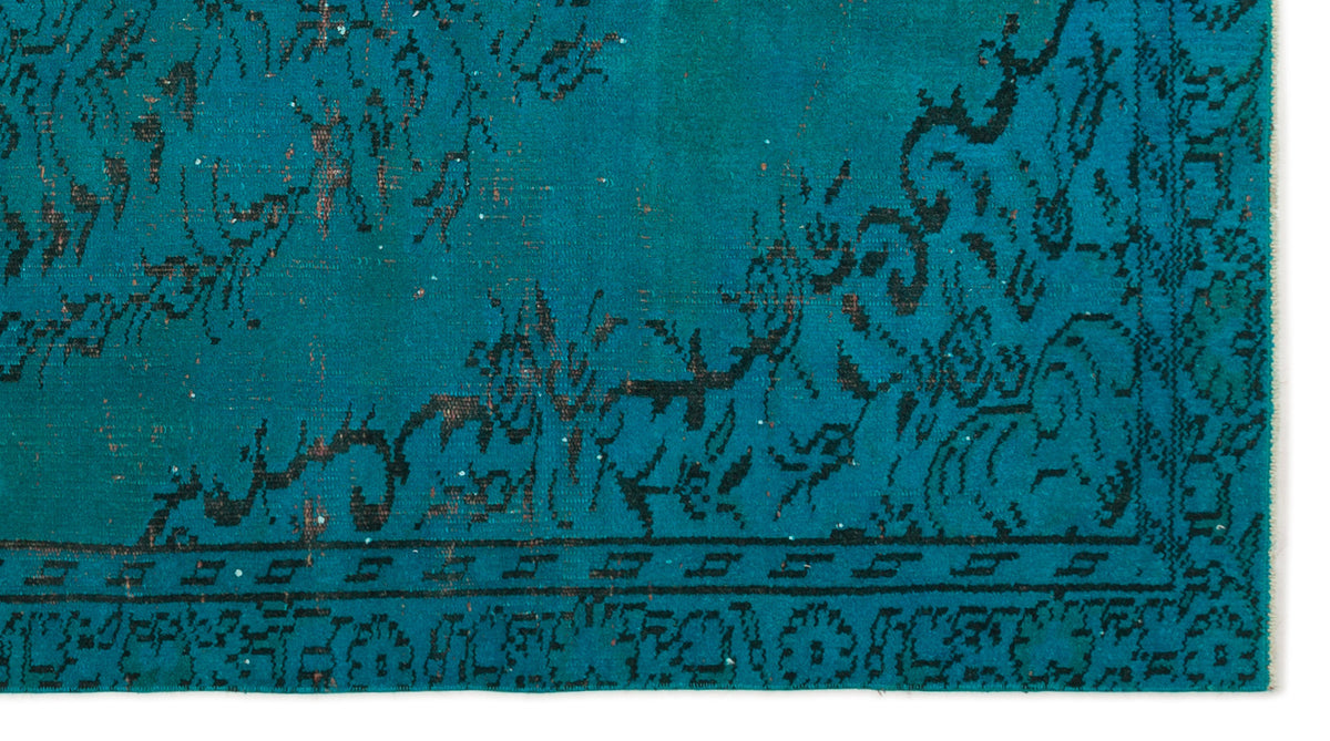 Teal rug with a distressed black traditional floral border and medallion pattern on a white background.