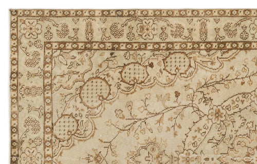 Load image 1 in gallery view. Beige and brown traditional rug with a distressed floral medallion pattern and a geometric border.