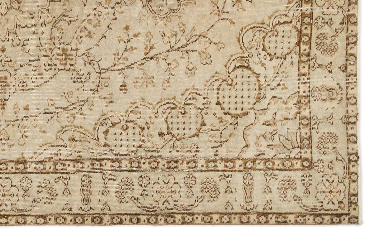 Beige and brown traditional rug with a floral vine pattern and a detailed geometric border.