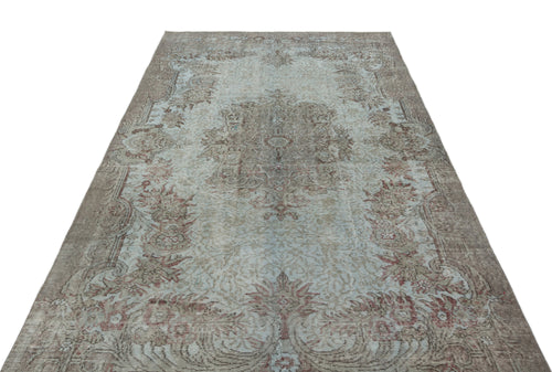 Load image 1 in gallery view. Distressed light blue and brown vintage-style rug with a central floral medallion and ornate border.