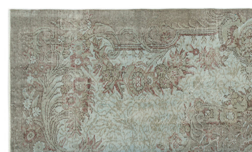 Load image 1 in gallery view. Distressed taupe and light blue rug with a traditional floral medallion pattern.