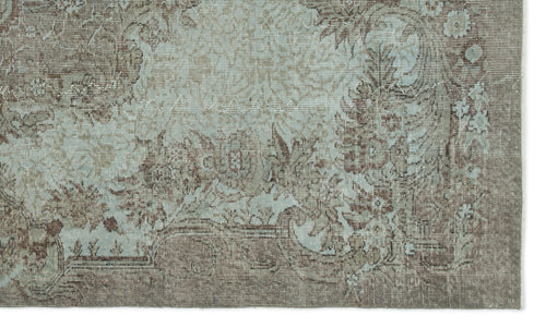 Load image 1 in gallery view. Distressed taupe and light blue rug with a traditional floral medallion pattern and ornate border.