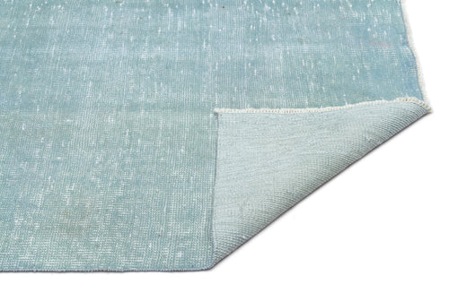 Load image 1 in gallery view. Distressed light blue rug with a white speckled pattern and a folded corner showing the woven backing.