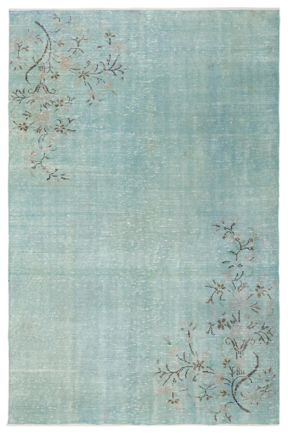 Distressed light blue rug with faded floral branch motifs in the top-left and bottom-right corners.