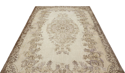 Load image 1 in gallery view. Beige and brown vintage-style rug with a central floral medallion and ornate border on a white background.