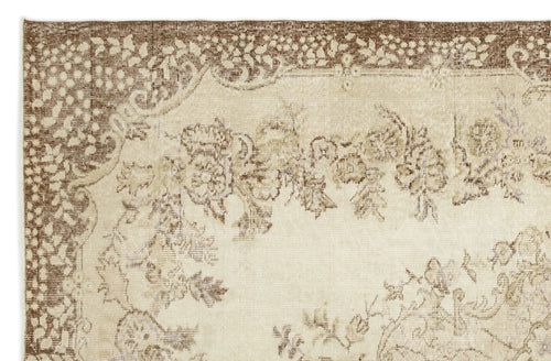 Load image 1 in gallery view. Beige and brown vintage-style rug with a distressed floral medallion pattern and ornate border.