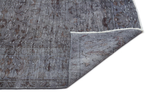 Load image 1 in gallery view. Grey and brown distressed traditional rug with a folded corner showing the woven backing and white fringe.