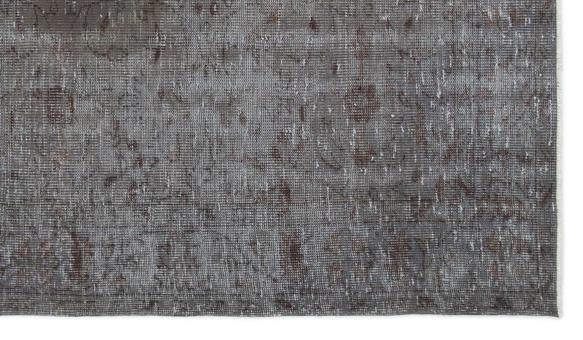 Grey and brown distressed rug with a faded traditional medallion pattern on a white background.