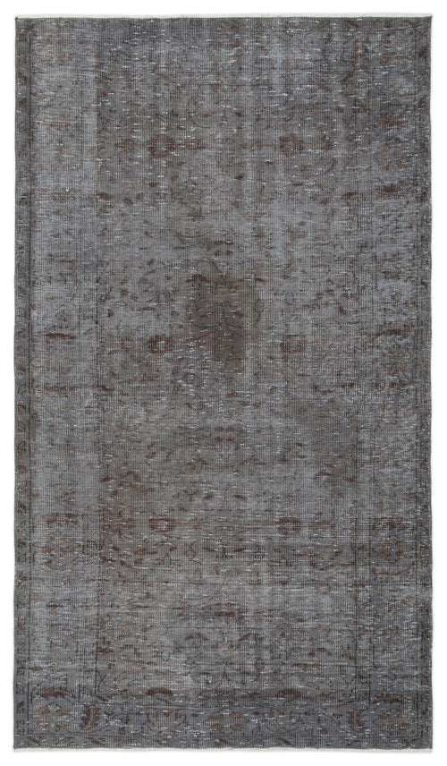 Load image 1 in gallery view. Charcoal and brown distressed vintage-style rug with a faded central medallion and ornate border pattern.