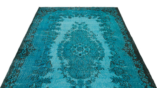 Load image 1 in gallery view. Turquoise and black distressed rug with a central floral medallion and ornate border on a white background.