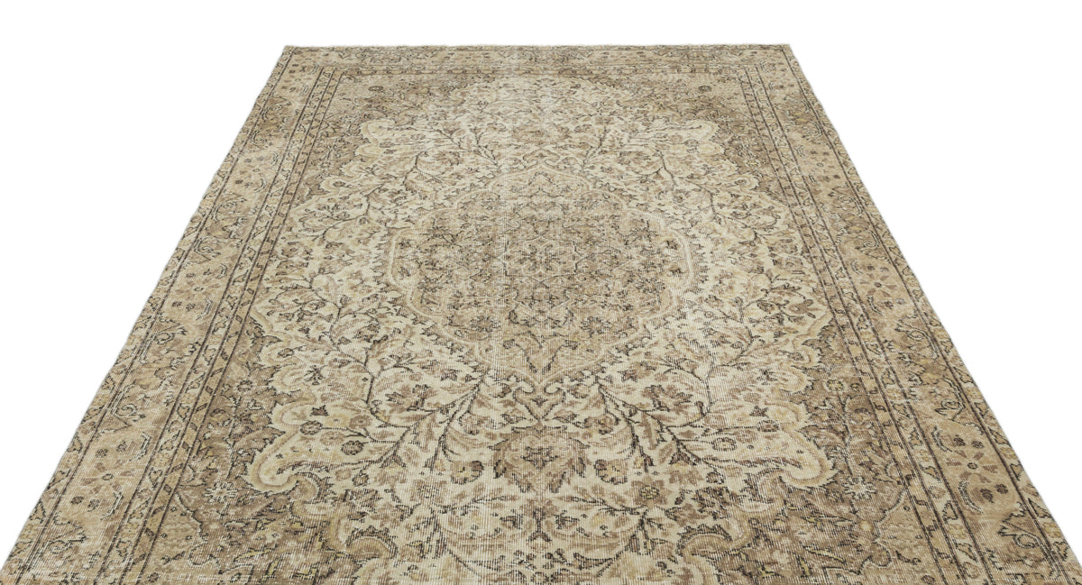 Beige and brown traditional rug with a distressed floral medallion pattern and ornate border on a white background.