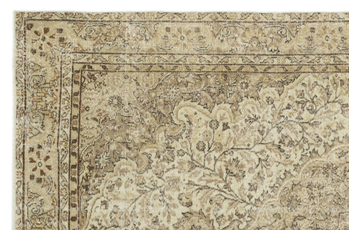 Load image 1 in gallery view. Beige and brown vintage-style rug with a distressed floral medallion pattern and a detailed geometric border.