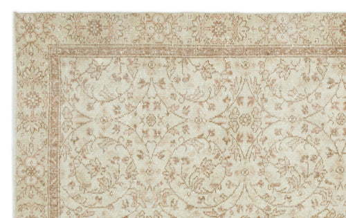 Load image 1 in gallery view. Beige and cream rug with a distressed floral medallion pattern and a decorative border.