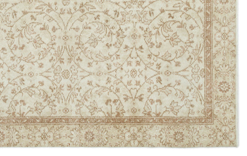 Load image 1 in gallery view. Beige and cream rug with a distressed traditional floral vine pattern and a decorative border.