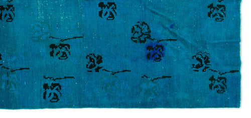 Load image 1 in gallery view. Bright blue rug with a distressed texture and scattered black floral motifs.