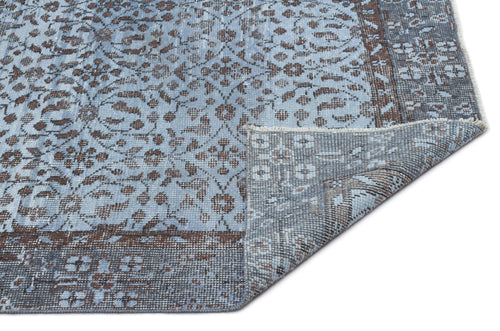 Load image 1 in gallery view. Light blue and brown traditional floral medallion rug with a folded corner showing the woven backing.