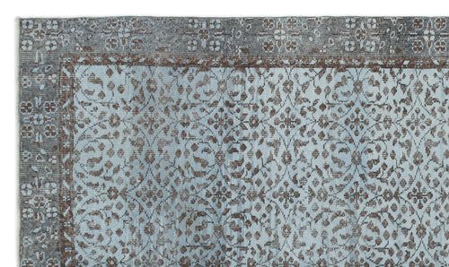 Load image 1 in gallery view. Light blue and brown rug with a distressed floral medallion pattern and a wide decorative border.