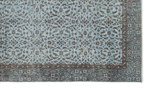 Load image 1 in gallery view. Light blue and brown rug with a distressed traditional floral medallion pattern and a wide decorative border.