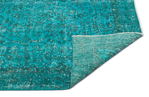 Load image 1 in gallery view. Teal and charcoal distressed traditional rug with a folded corner showing the woven backing.