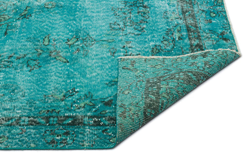 Load image 1 in gallery view. Teal and dark green distressed vintage-style rug with a folded corner showing the woven backing.