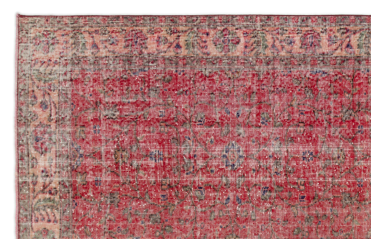 Red and peach distressed traditional rug with a faded floral medallion pattern and a decorative border.