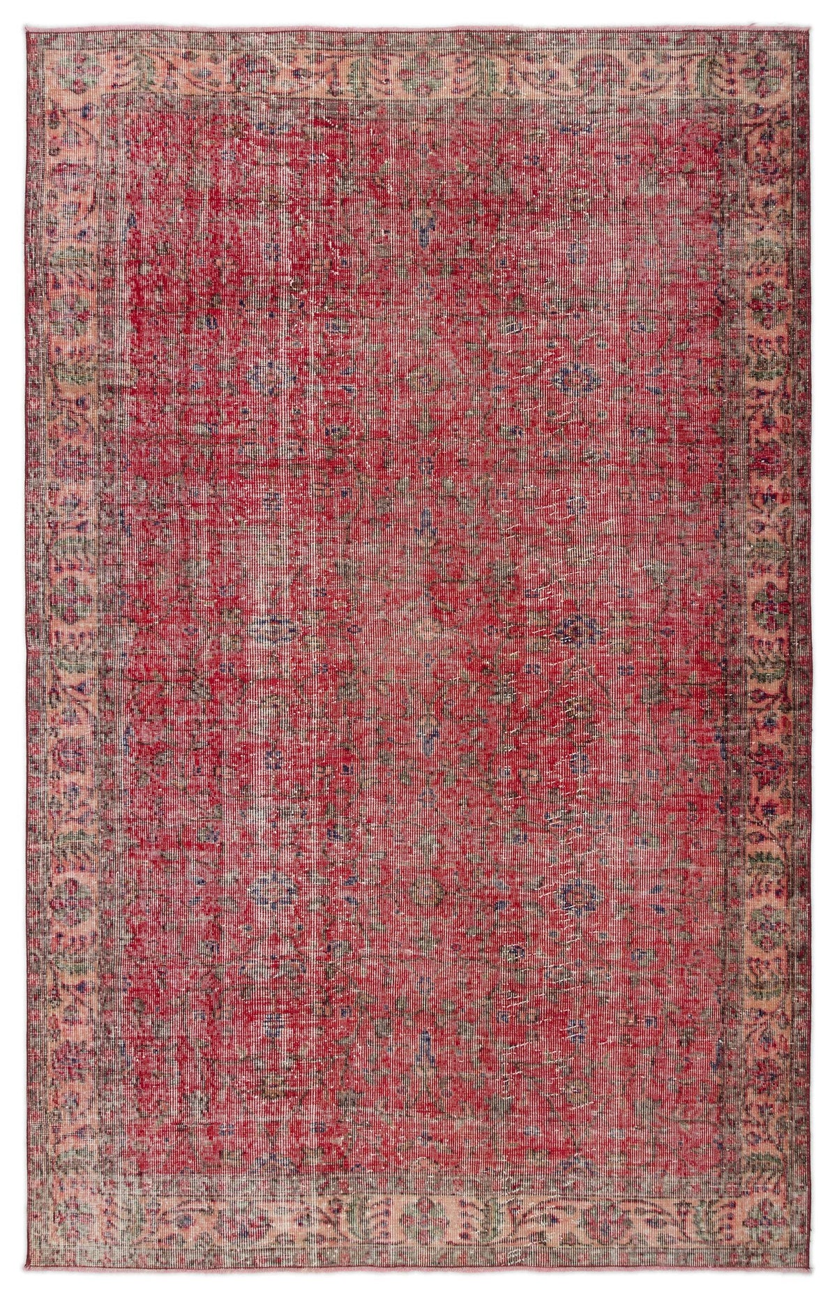 Distressed red vintage-style rug with a faded floral medallion pattern and a wide, muted border.