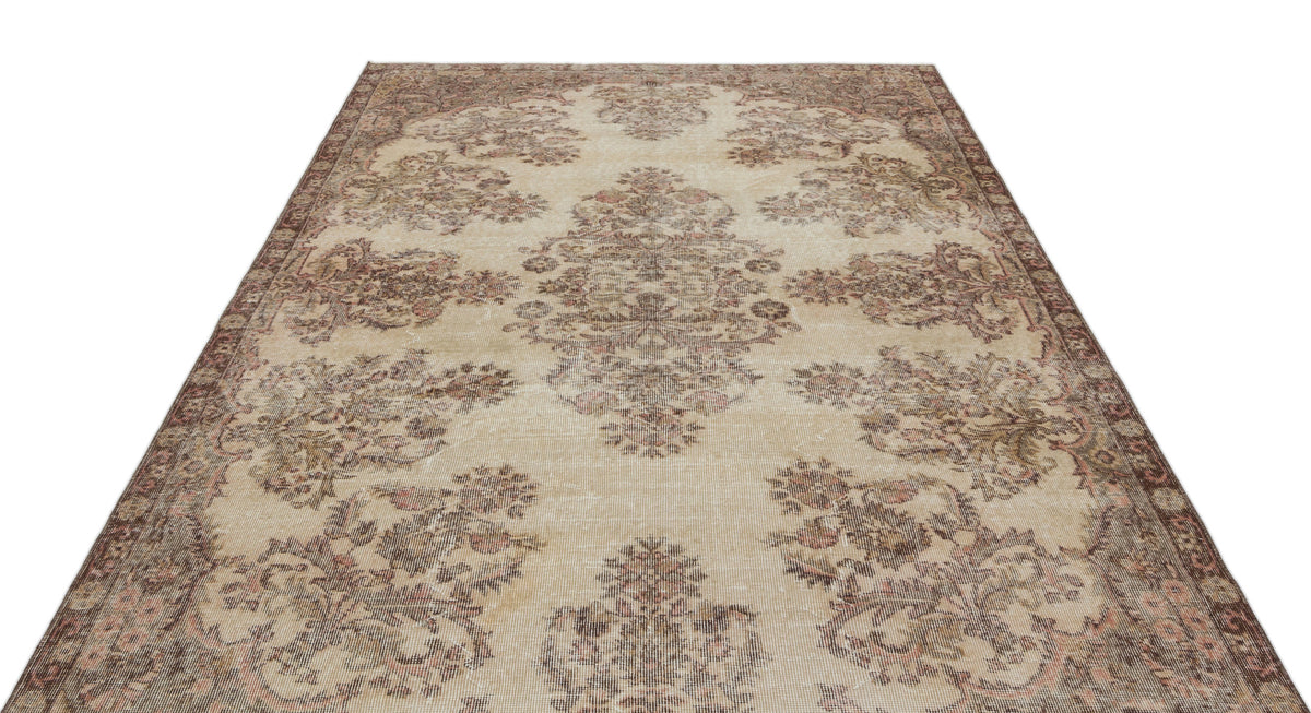 Beige and brown vintage-style rug with a distressed floral medallion pattern on a white background.