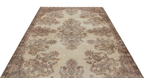 Load image 1 in gallery view. Beige and brown vintage-style rug with a distressed floral medallion pattern on a white background.