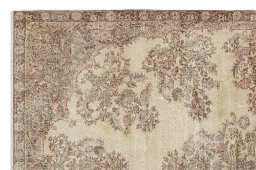 Load image 1 in gallery view. Beige and brown vintage-style rug with a distressed floral medallion pattern and a decorative border.