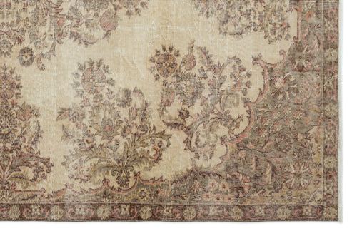 Load image 1 in gallery view. Beige and brown vintage-style rug with a distressed floral medallion pattern and a decorative border.