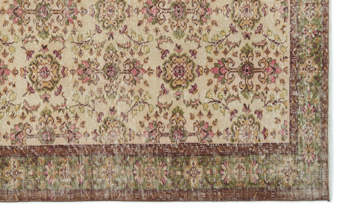 Load image 1 in gallery view. Beige traditional rug with a distressed floral medallion pattern in pink, green, and brown, featuring a wide border.