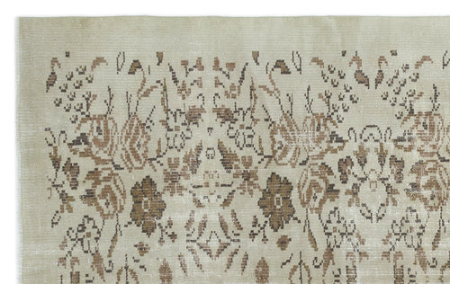 Load image 1 in gallery view. Beige rug with a distressed brown floral medallion pattern and a textured, low-pile weave.