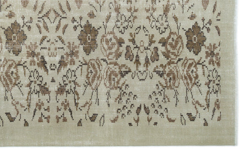 Load image 1 in gallery view. Beige and brown distressed rug with a faded floral pattern.