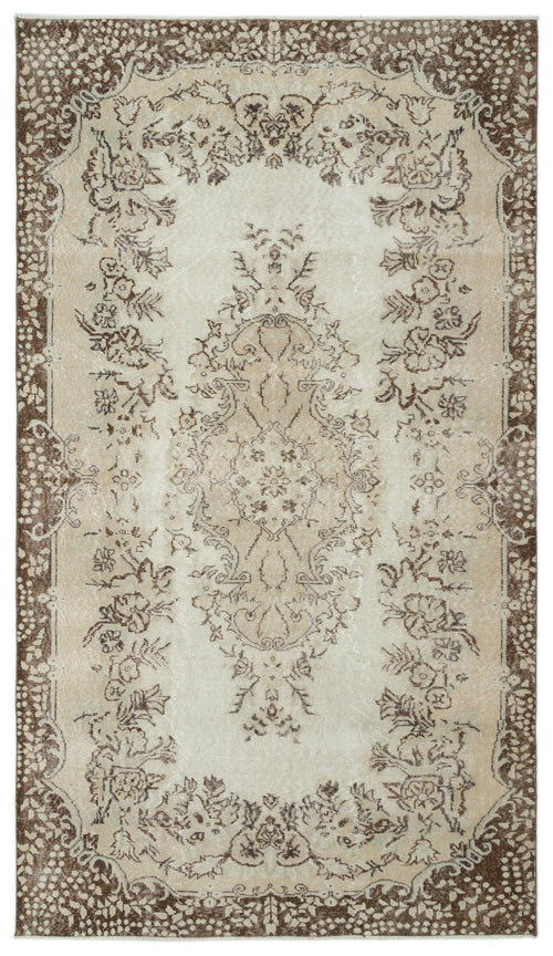 Load image 1 in gallery view. Beige and brown vintage-style rug with a central floral medallion and a decorative border on a white background.