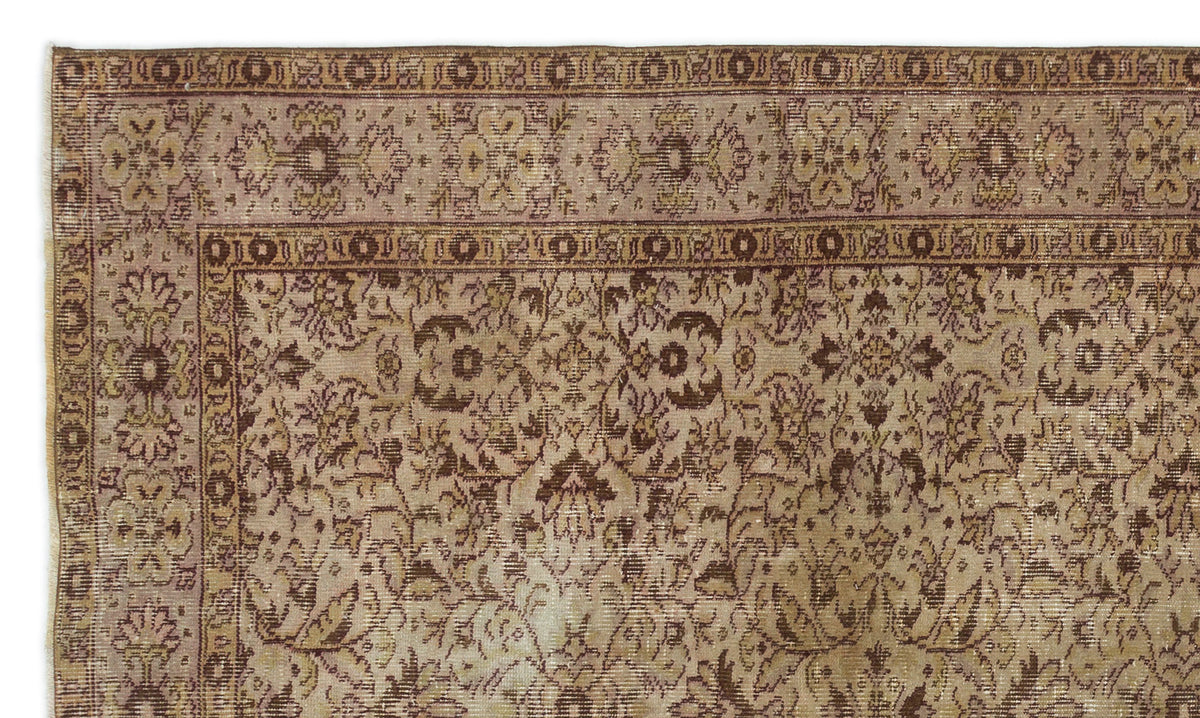 Distressed brown and beige vintage-style rug with an intricate floral medallion pattern and a wide decorative border.