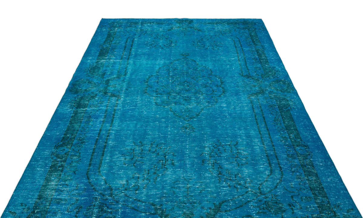Bright blue distressed rug with a traditional central medallion and border pattern on a white background.