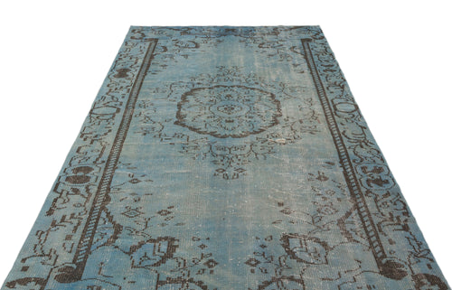 Load image 1 in gallery view. Distressed light blue rug with a dark brown central medallion and ornate border pattern on a white background.