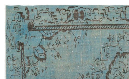 Load image 1 in gallery view. Distressed turquoise rug with a dark charcoal geometric border and abstract, faded traditional motifs.