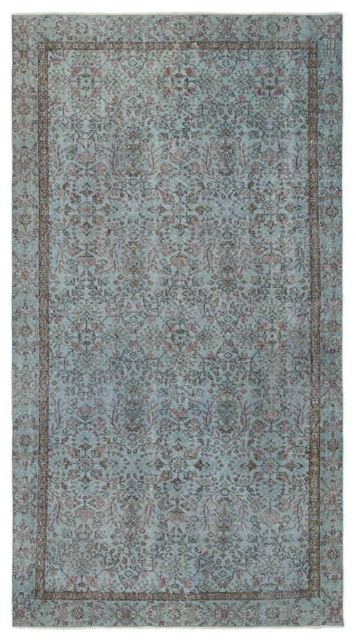 Load image 1 in gallery view. Light blue and brown vintage-style rug with a distressed floral medallion pattern and a decorative border.
