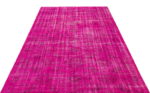 Load image 1 in gallery view. Fuchsia distressed vintage-style rug with a faded floral medallion pattern on a white background.